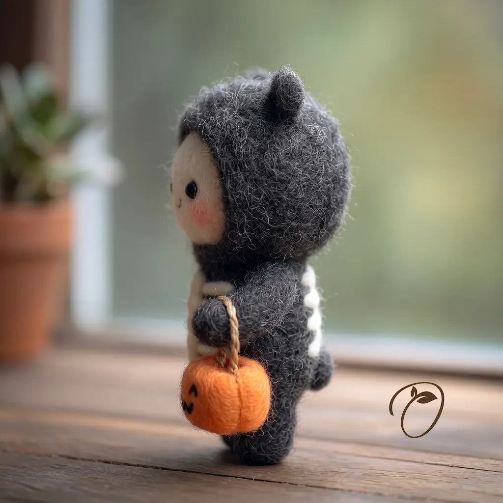 Side view of a felt skeleton costume character with a rosy cheek and pumpkin pail hanging from a cord handle