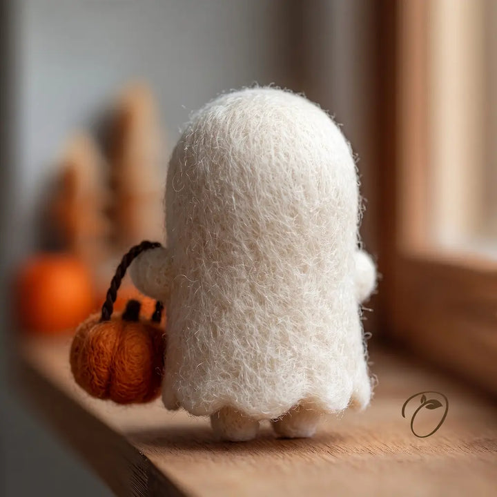 Back view of Pumpkin Basket Ghost wool felt figurine with a scalloped hem and an orange basket with a brown handle
