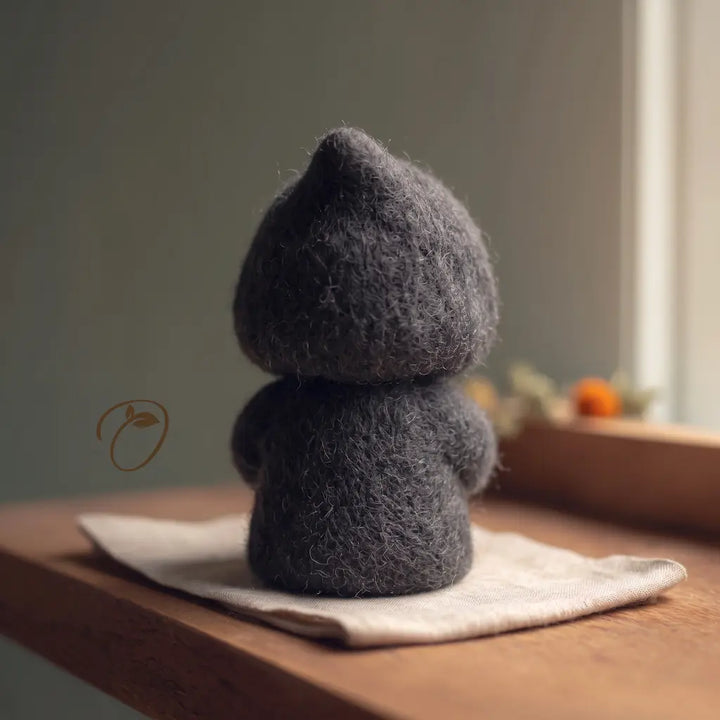 Back view of the Ghost Hug Reaper felt figurine, showing its pointed charcoal hood, rounded shoulders, and wool robe.