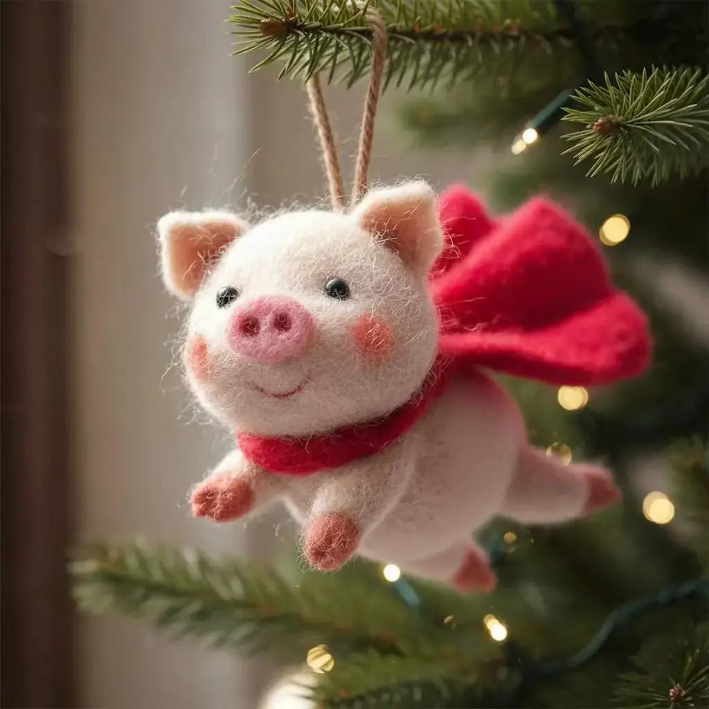Felted pig ornament with a red bow tie hanging on a Christmas tree.