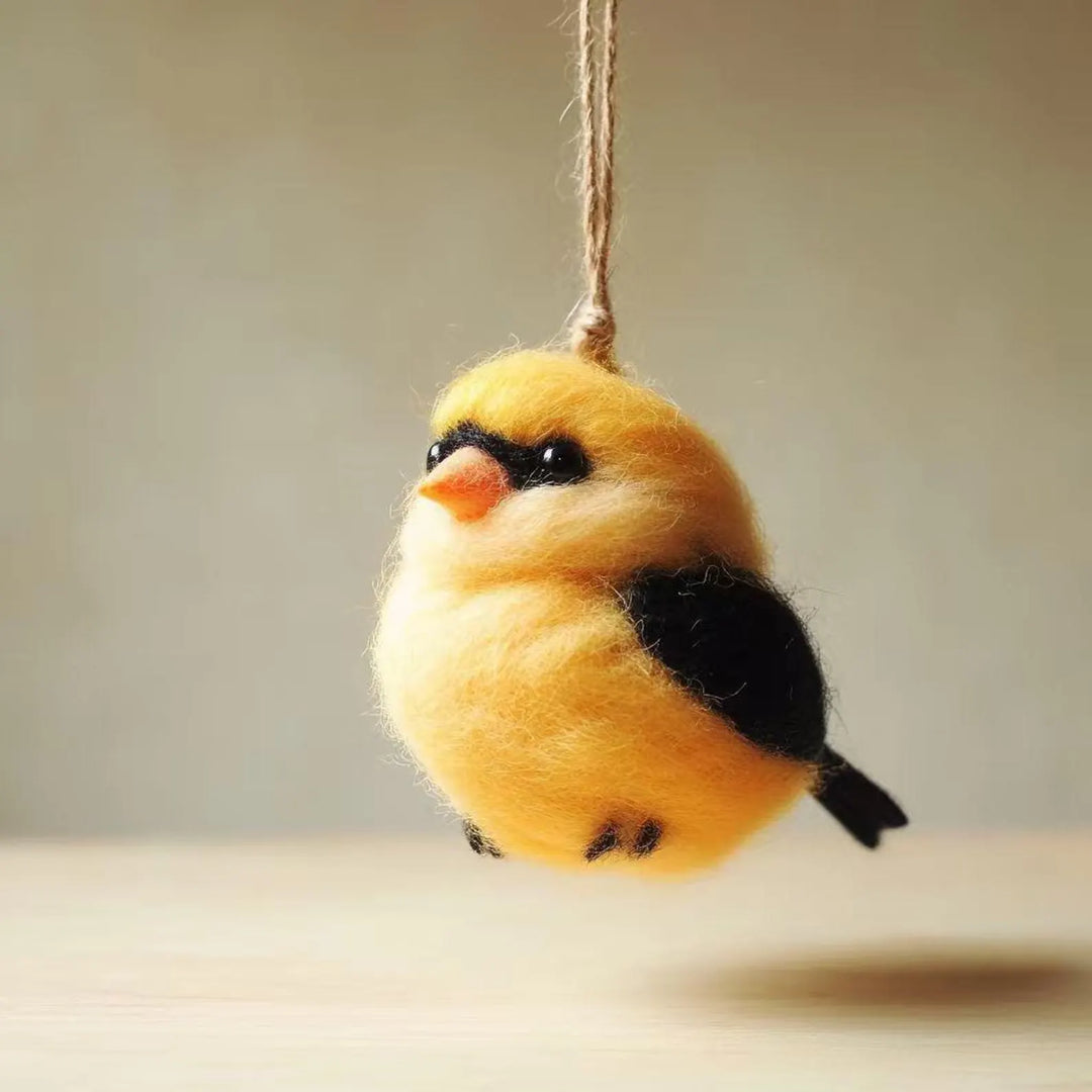Yellow bird ornament hanging on a string against a neutral background