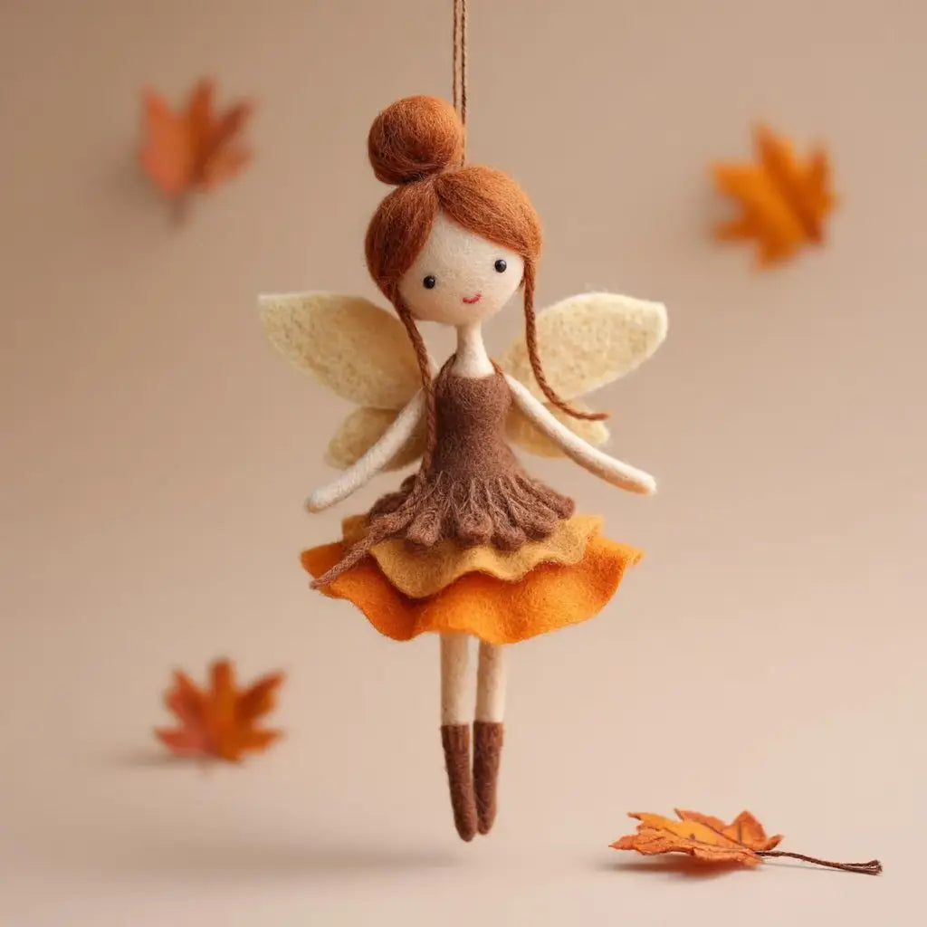 Felt fairy doll with autumn-themed outfit hanging against a beige background with leaves.