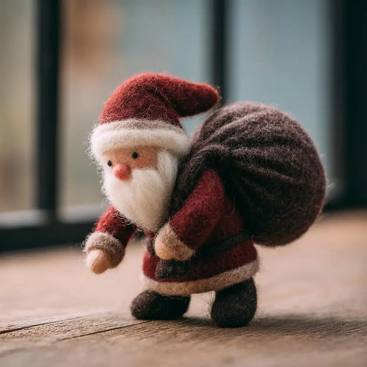 Small Santa Claus figurine with a sack on a wooden surface
