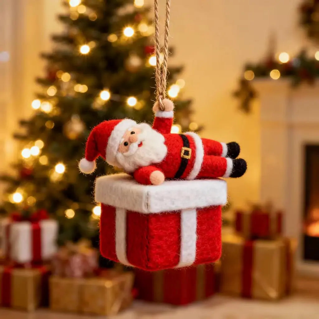 Decorative Christmas ornament of Santa Claus on a present with a festive background.
