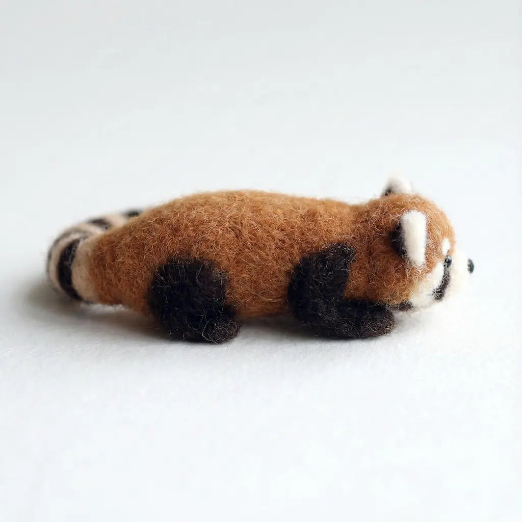Stuffed toy red panda on a white background