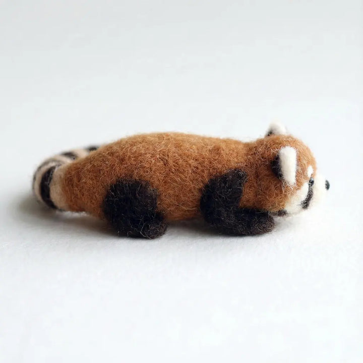 Stuffed toy red panda on a white background