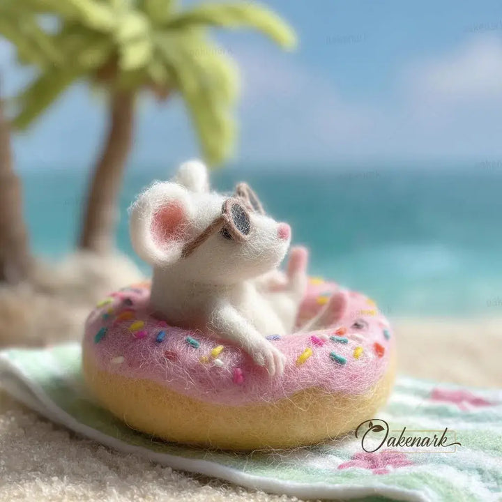 Small animal figure on a pink donut with sprinkles at a beach setting