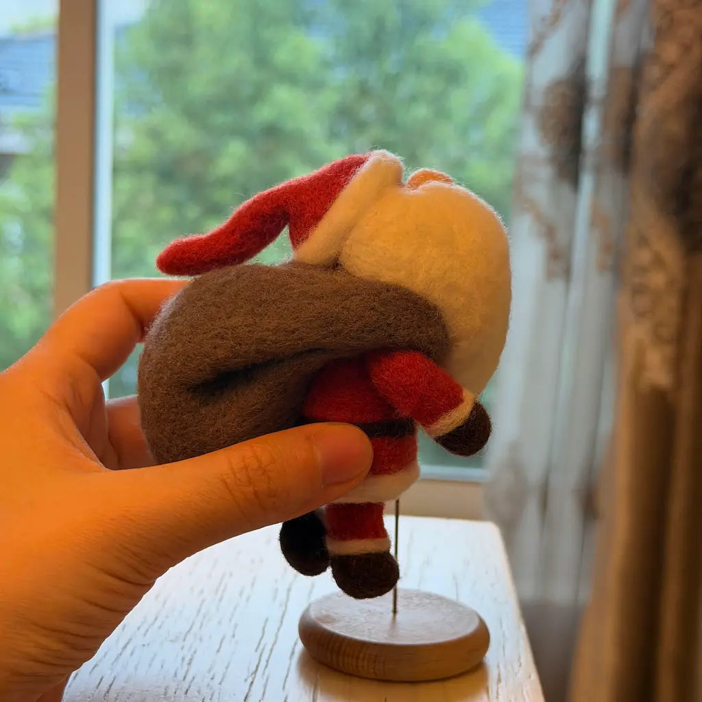 Handmade Walking Santa felt figurine in a forward walking pose