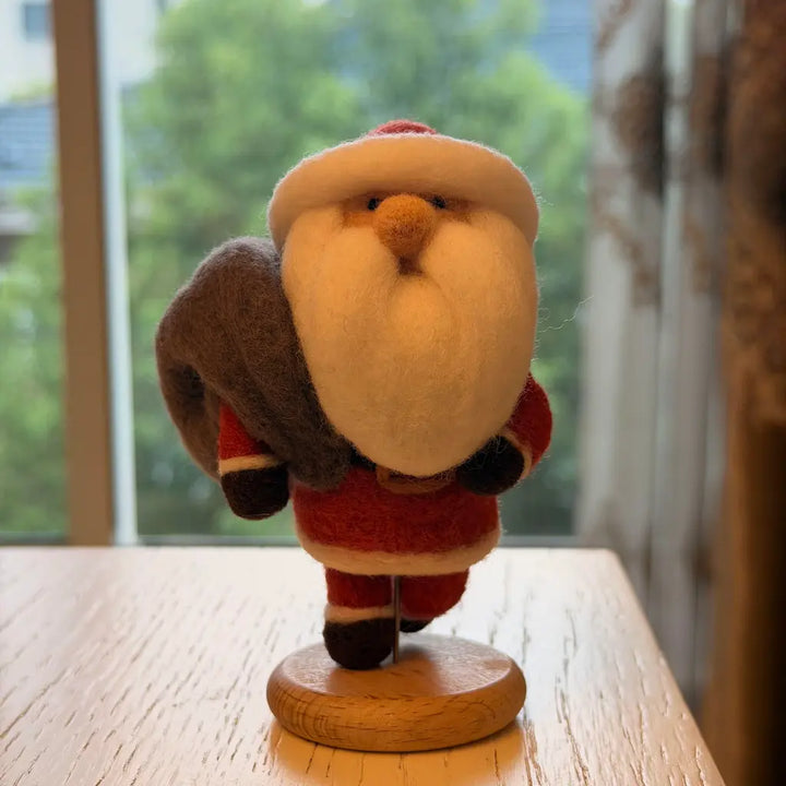 Handmade Santa wool felt figurine captured mid-stride