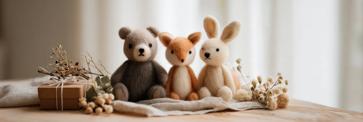 Handmade wool felt bear, fox and bunny displayed with a gift box and dried flowers