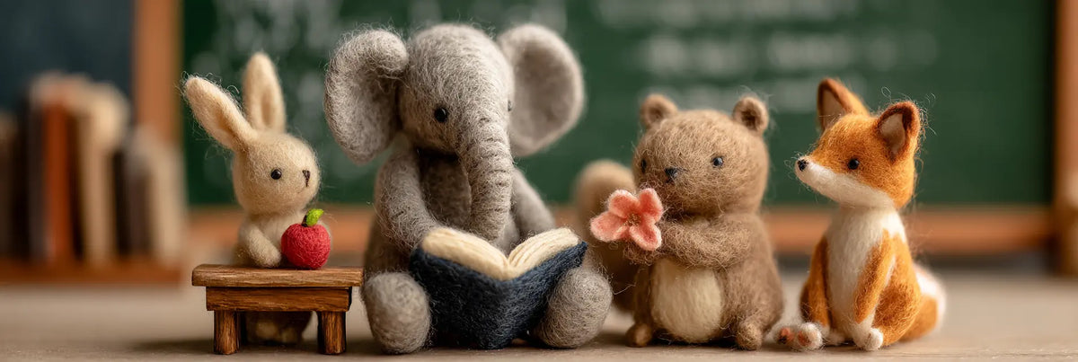 Handmade wool felt elephant teacher reading to bunny, bear and fox students in a cozy classroom