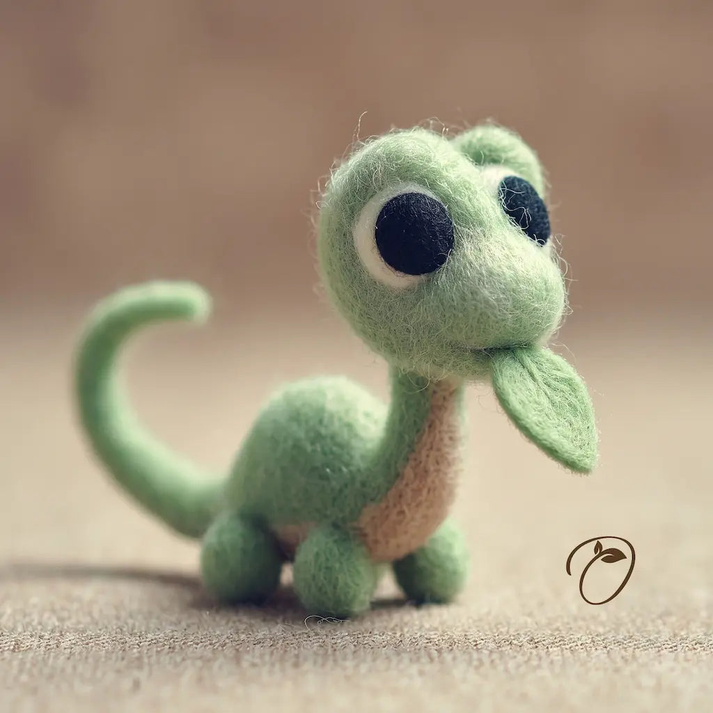 A small felt dinosaur figurine in light green with a beige underside, large black eyes, and a leaf-shaped nose, standing on a soft beige surface against a blurred warm background.
