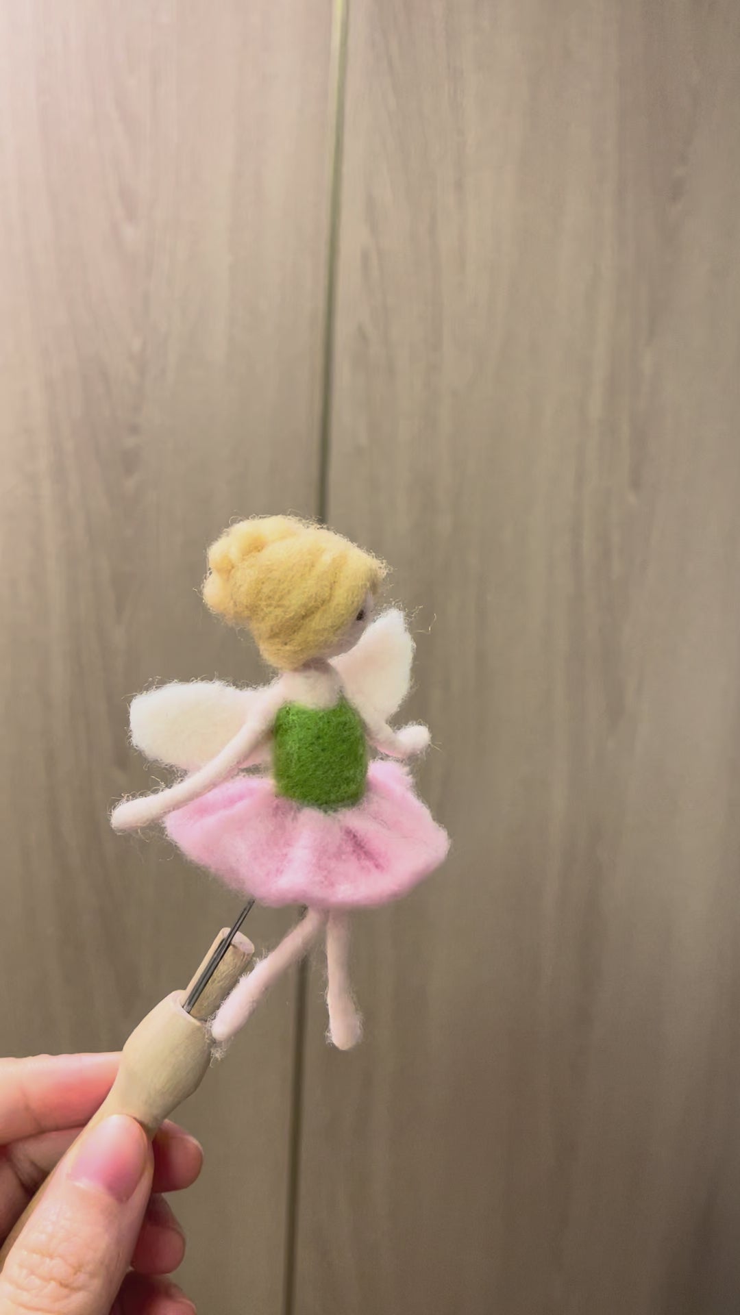 Felted Fairy doll with a pink dress and green top on a white background