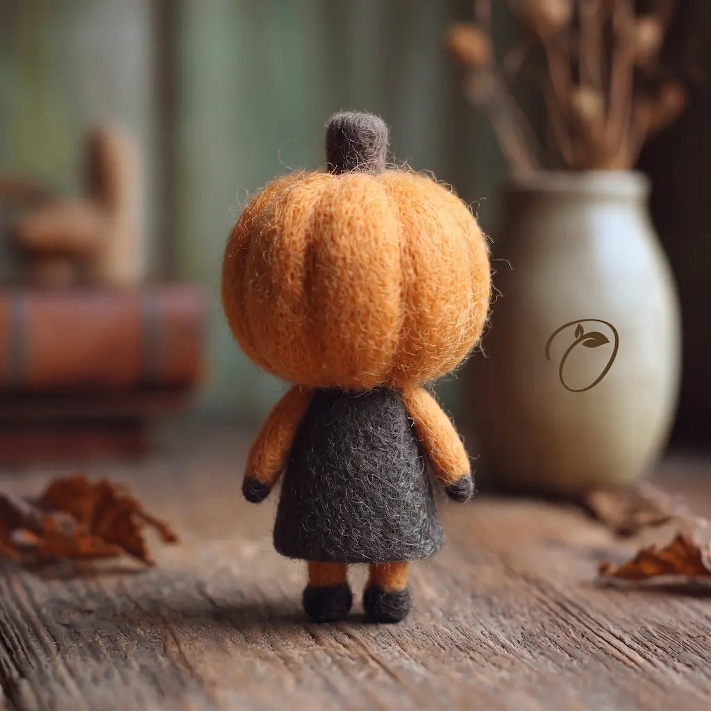 Back view of Pumpkin Trickster felt figurine showing pumpkin head and dark dress