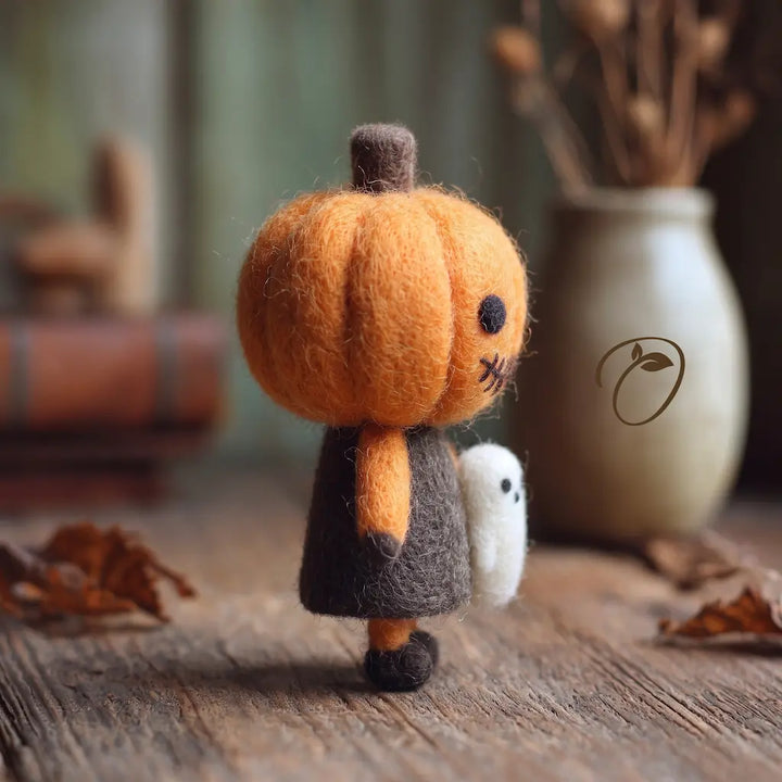 Side view of Pumpkin Trickster felt figurine with small ghost companion