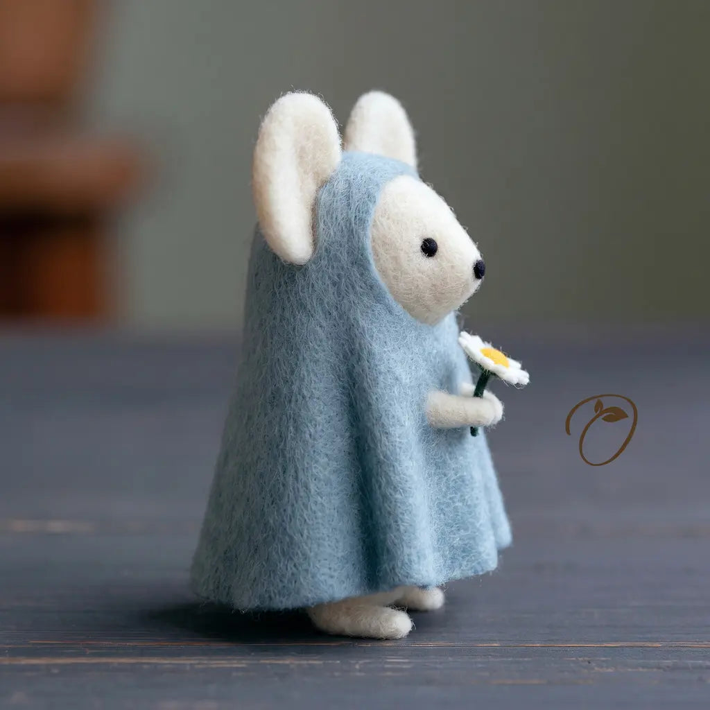 Side view of a felt mouse figurine holding a miniature daisy