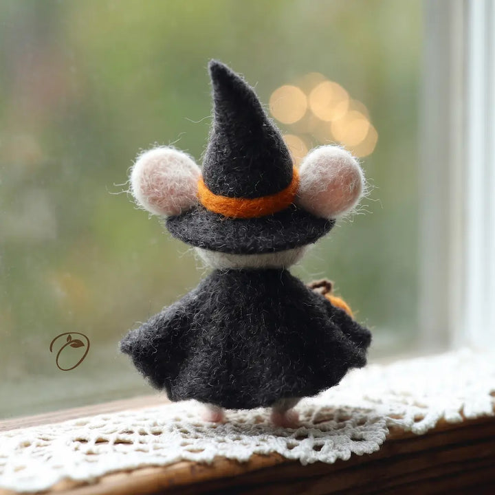 Back view of handmade witch mouse figurine with flowing black felt cape