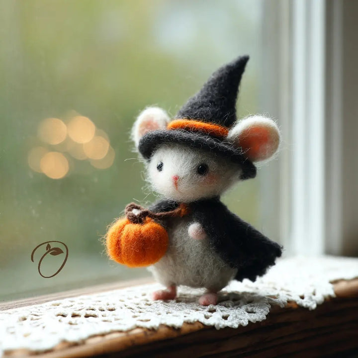 Side view of felt Halloween mouse wearing a black witch hat and cape