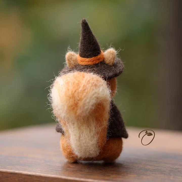 Back view of handmade witch squirrel with a large curled wool tail