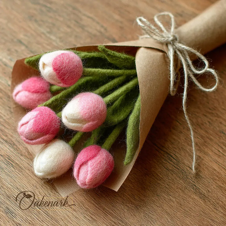 Bouquet of felt tulips wrapped in brown paper with string on a wooden surface, featuring the Outenark brand.