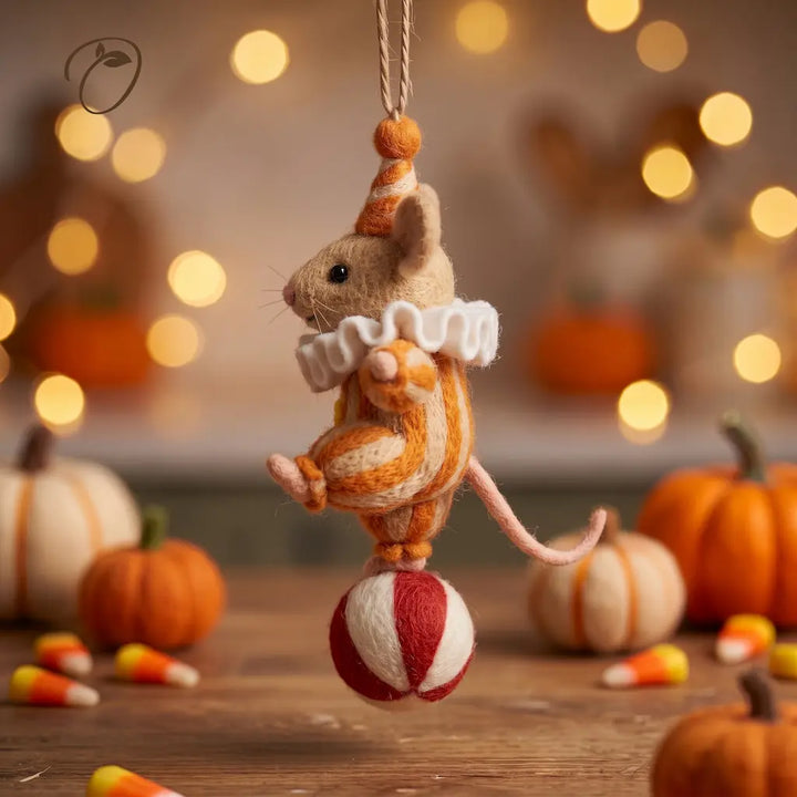 Side view of Carnival Mouse felt ornament with a pointed party hat, curved pink tail and striped circus ball